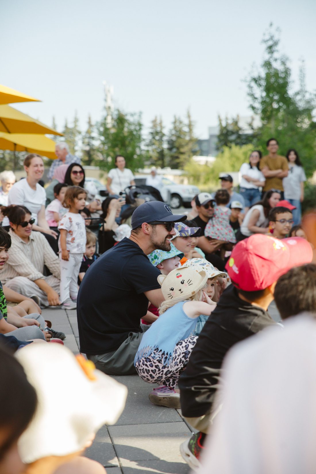 Kids and parents sitting in for a market performance