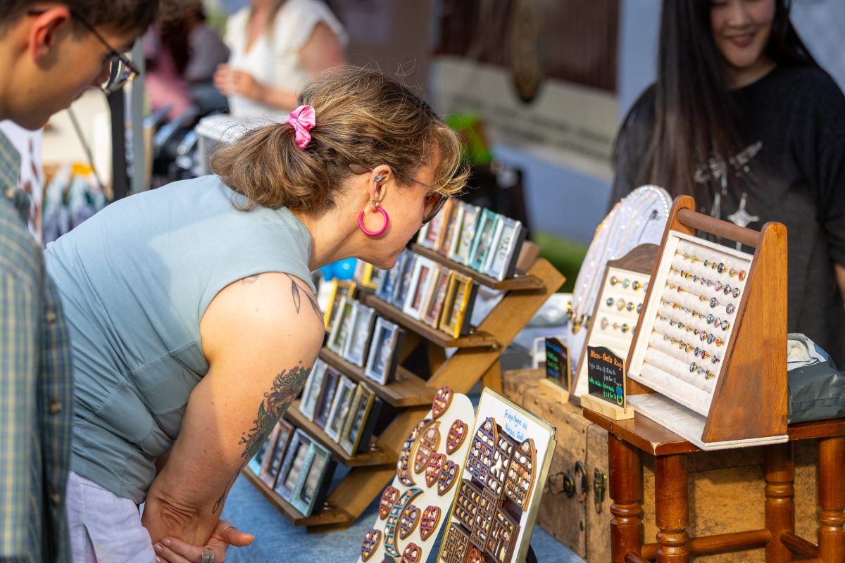 Shopper browsing handmade jewellery and shell art
