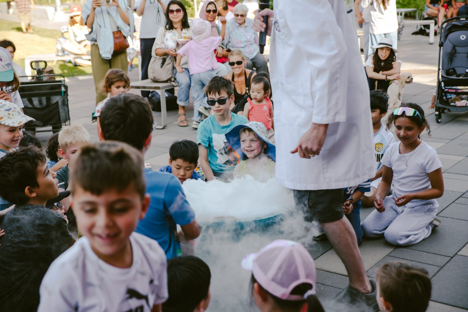 Kids gathered around a science demonstration at the market